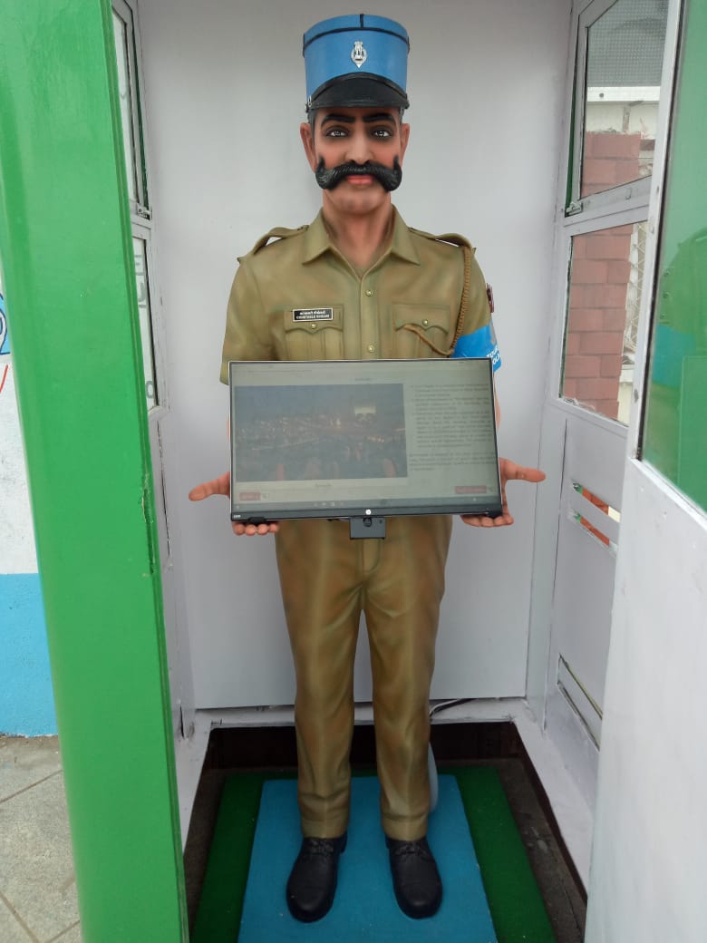 Pondicherry's robocop Constable Singam stands on Beach Road with a touch-screen in his hand to help tourists