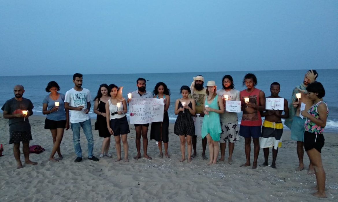 candle light vigil on serenity beach for victims of mob lynching in assam